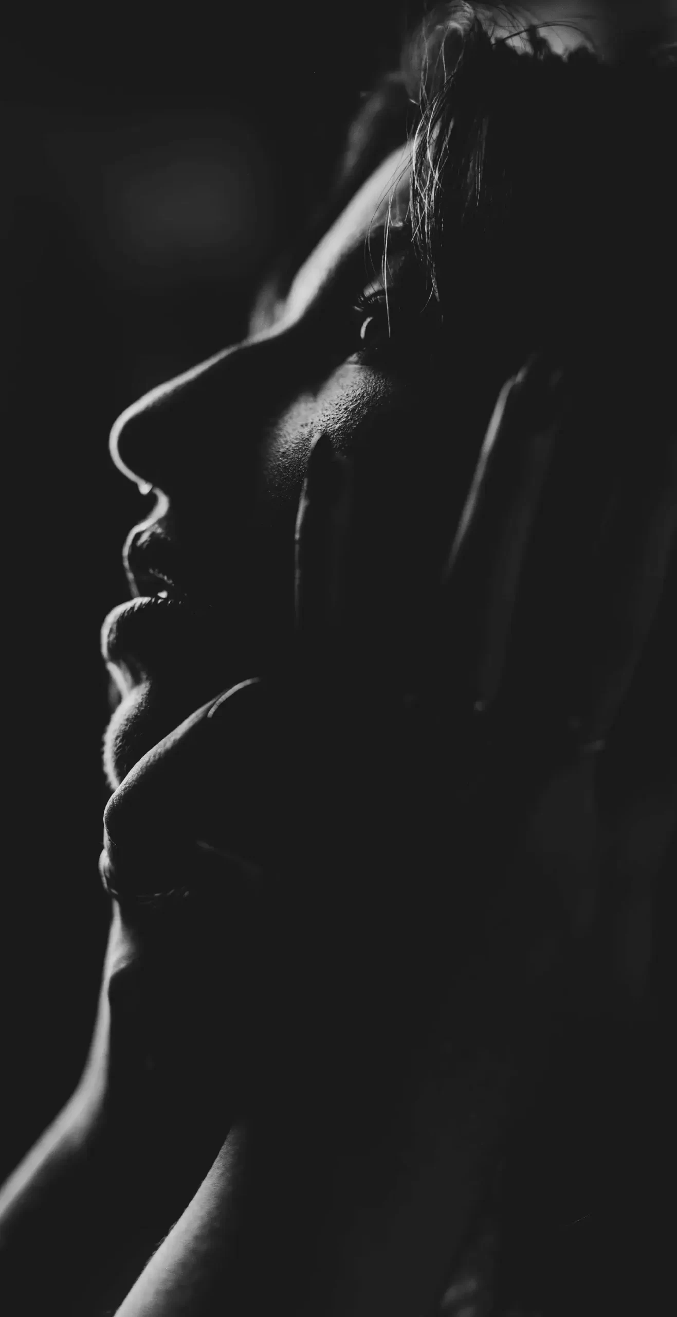 Dramatic monochrome profile portrait of a woman looking up for modern editorial design