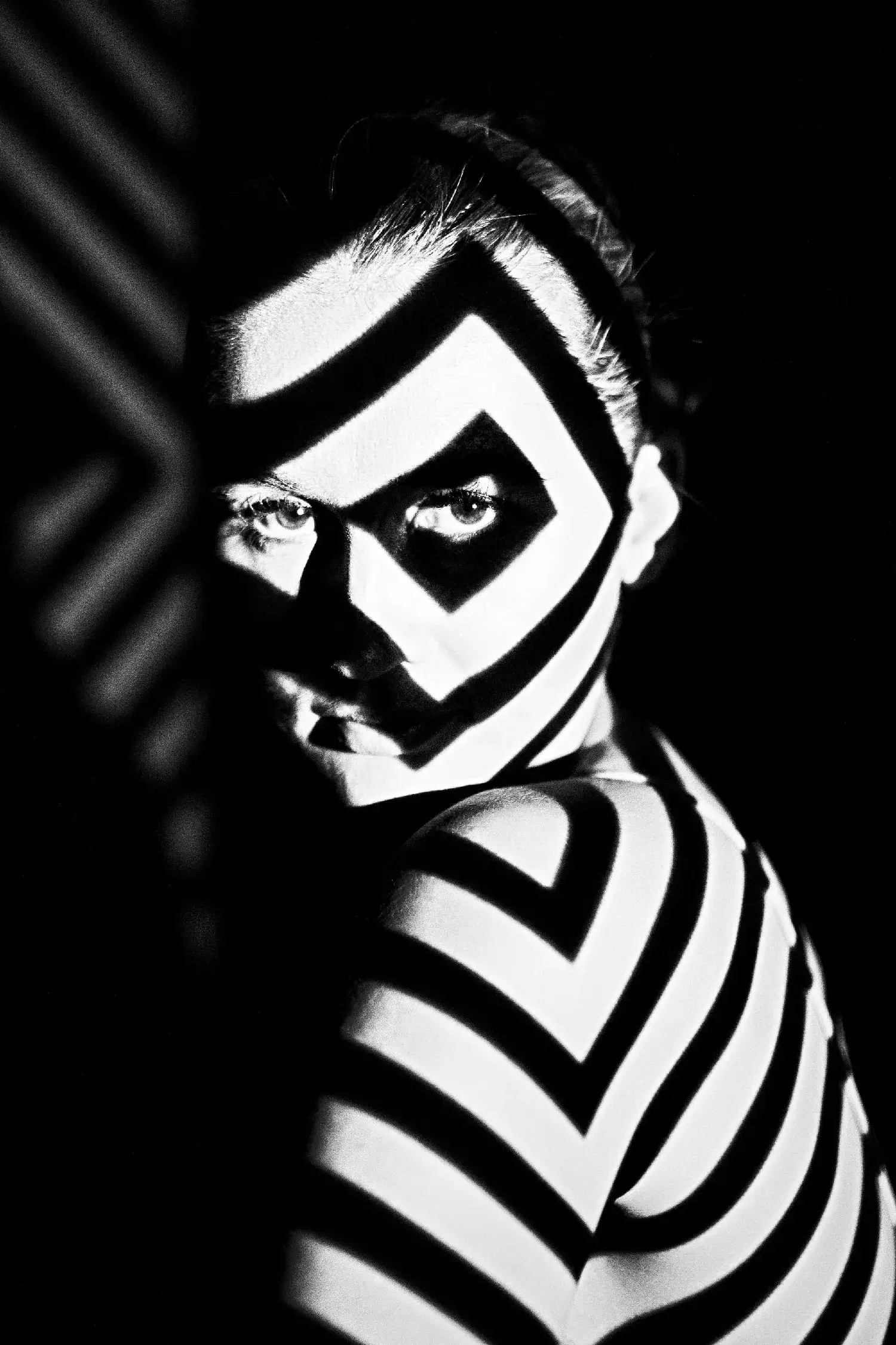 High contrast graphic geometric light lines pattern projection photography on a woman face architecture