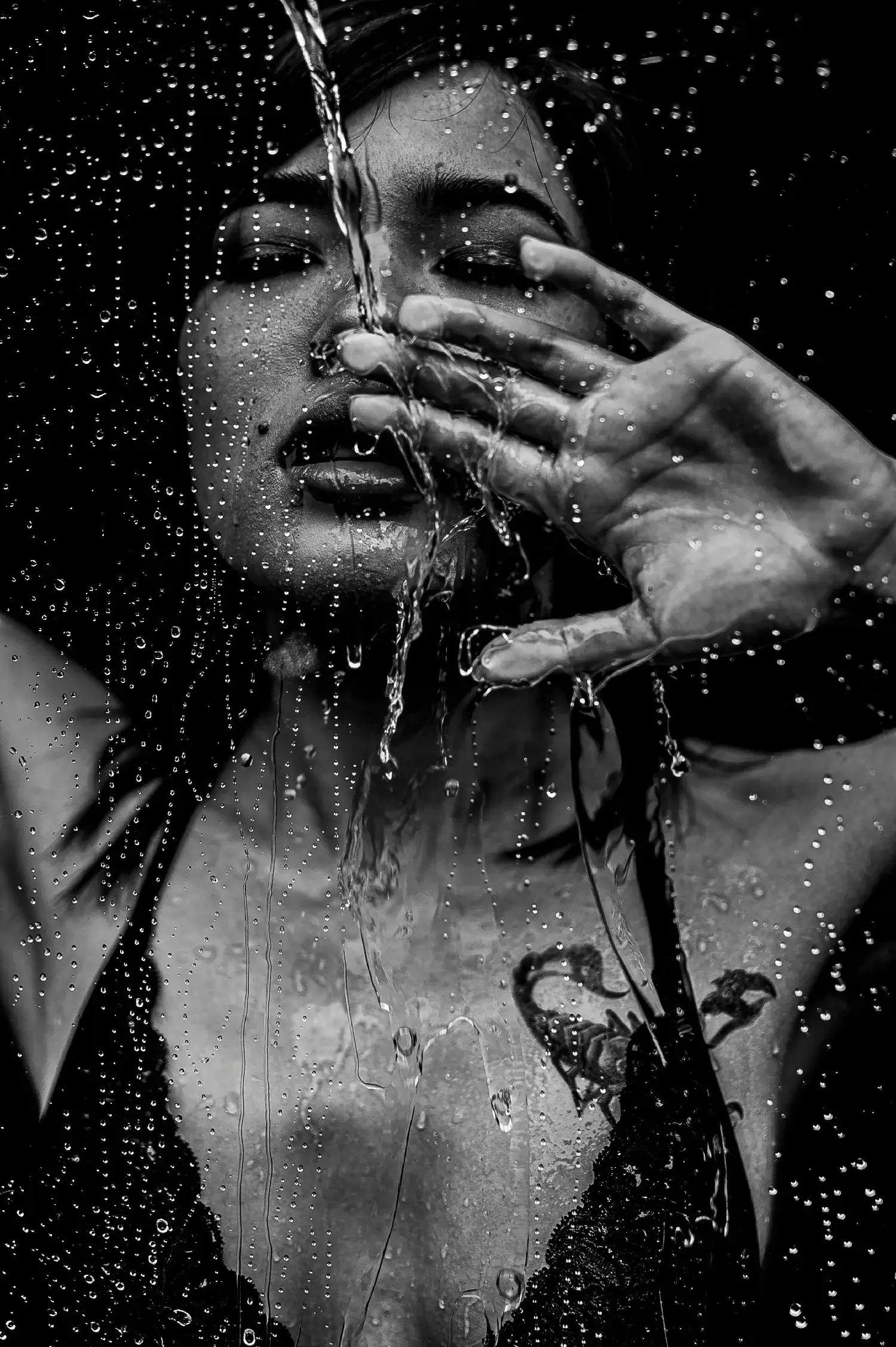 Aesthetic wet look fashion portrait profile of a woman inside dark textured studio waters