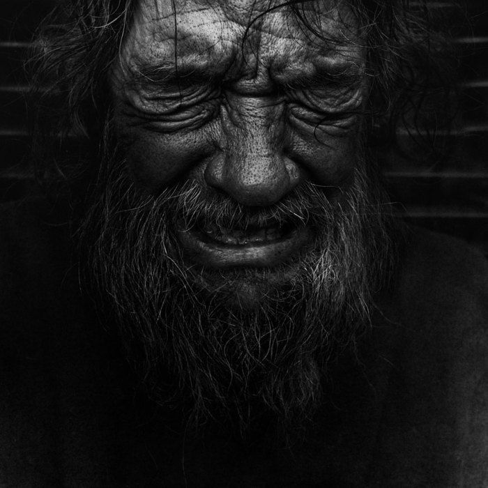 Ultra low key abstract black and white portrait where only eyes and textures emerge from deep black canvas.
