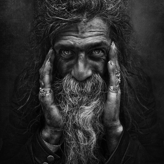 Detailed monochrome close up layout of an elderly person with an iconic long white beard and wrinkled skin.